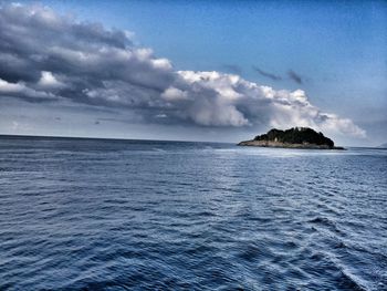 Scenic view of sea against cloudy sky