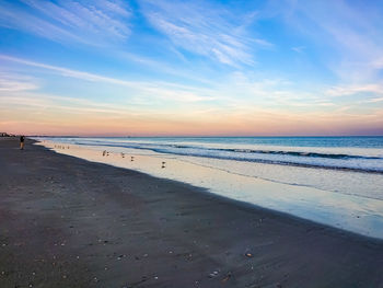 Scenic view of beach against sky during sunset