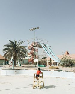 High angle view of lifeguard sitting on seat