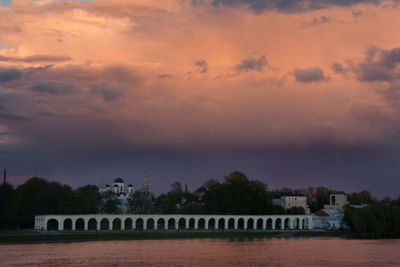 Scenic view of river against sky at sunset