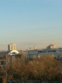 Sea by city against clear sky