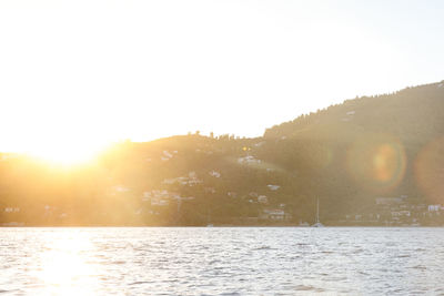 Scenic view of bright sun over water