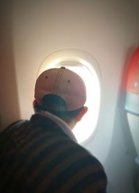 Rear view of man in airplane