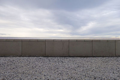 View of wall against cloudy sky