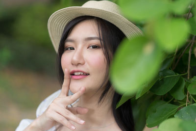 Close-up portrait of young woman wearing hat