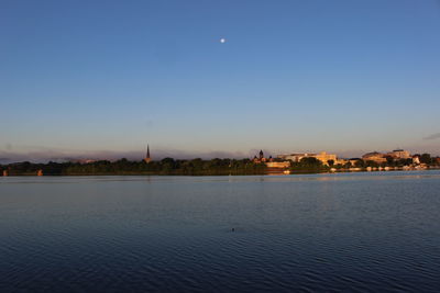 Buildings against clear sky with waterfront