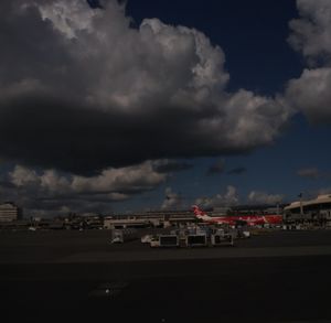 View of cityscape against cloudy sky