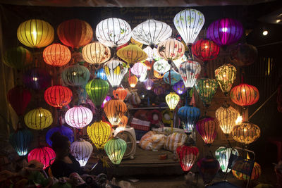 Low angle view of illuminated lanterns hanging at night