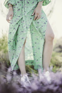 Low section of woman standing on ground