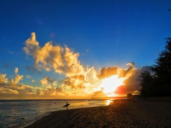 Scenic view of beach against sky during sunset