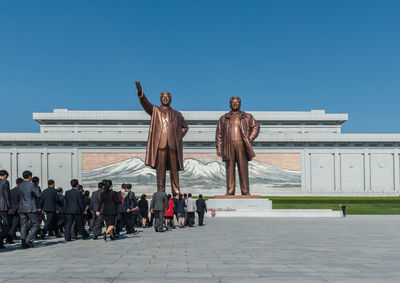 People against clear blue sky