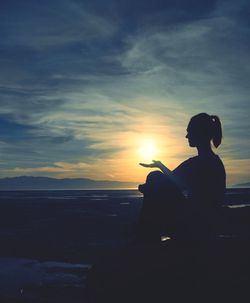 Silhouette of people looking at sunset