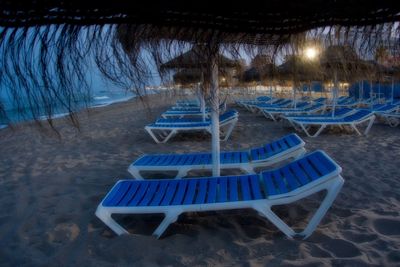 Close-up of chairs on beach