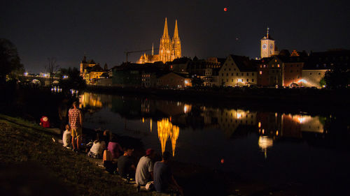 Reflection of illuminated buildings in lake at night