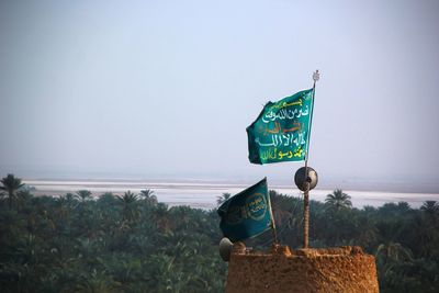 Information sign on land against sky