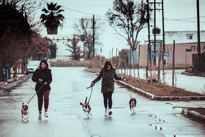 People with dog on snow during winter