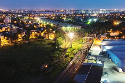High angle view of illuminated cityscape against sky at night