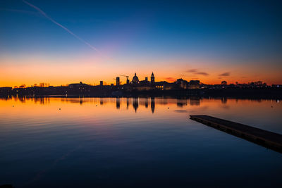 Scenic view of  mantua's old town by silhouette buildings against sky during sunset