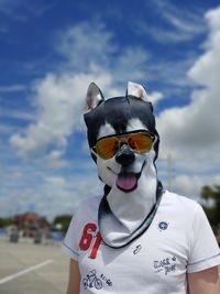 Portrait of man wearing sunglasses standing against sky