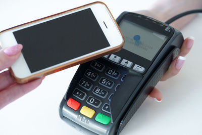 Close-up of hand holding mobile phone