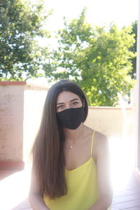 Portrait of beautiful woman against tree