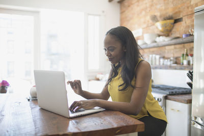 Businesswoman working on her laptop from home