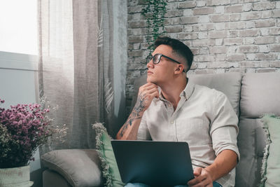 Young man using laptop at home