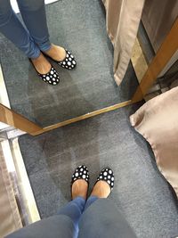 Low section of woman standing on tiled floor