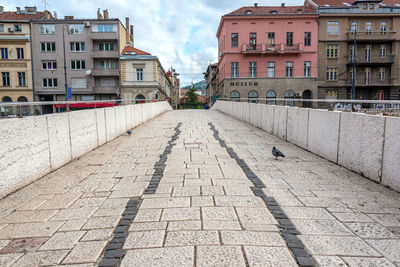 Footpath amidst buildings in city