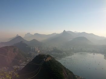 High angle view of mountains and sea against blue sky