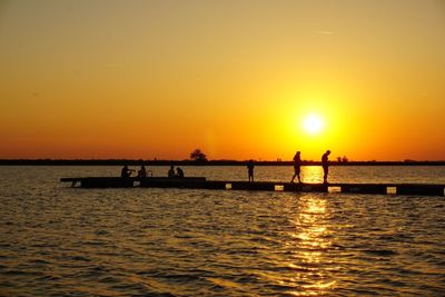 Scenic view of sea against orange sky