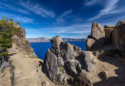 Panoramic view of rocks and sea against sky