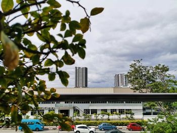 Cars by building against sky