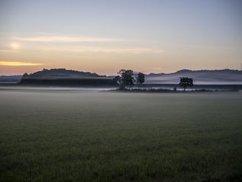 Scenic view of field against sky during sunset