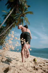 Low angle view of man running on beach