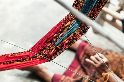 Close-up of hand holding multi colored umbrella