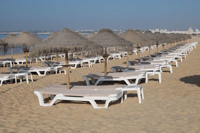 Deck chairs arranged at beach