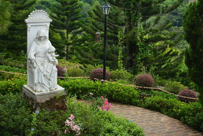 Statue amidst trees and plants