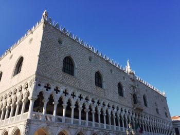 Low angle view of historical building against blue sky