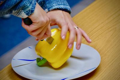 Close-up of woman preparing food on table