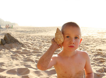 Portrait of cute girl sitting at beach