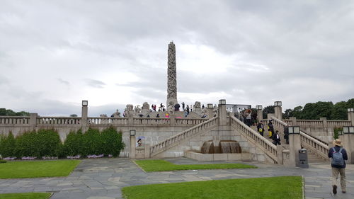 View of monument in city against cloudy sky