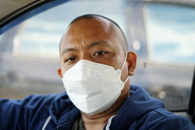 Close-up portrait of man wearing mask