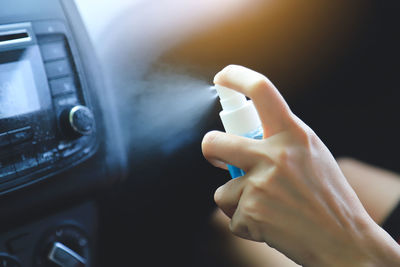 Close-up of human hand in car