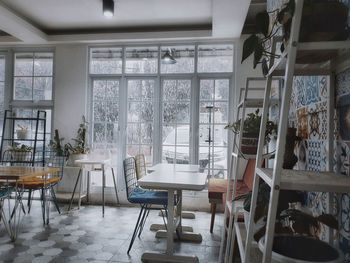 Empty chairs and tables in restaurant