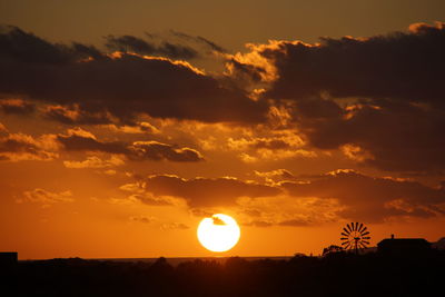 Silhouette trees against sky during sunset