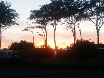 Silhouette of trees against sky at sunset