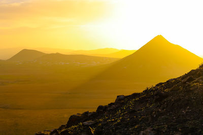 Scenic view of mountains against sky during sunset