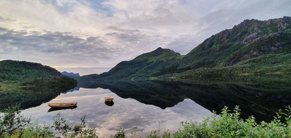 Scenic view of lake and mountains against sky