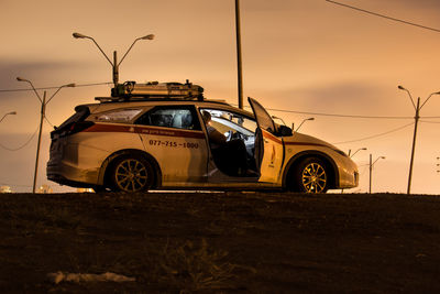 View of cars on road at sunset